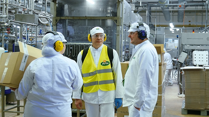Workers at the Arla factory in Finland chat.
