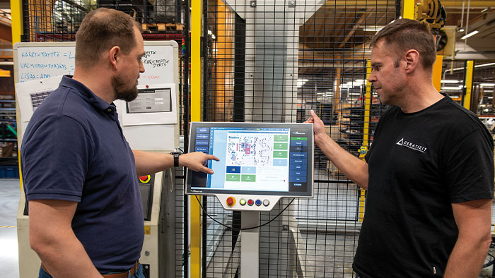 Juho Pulakka (left) and Hannu Tapio (right) discuss the programming of the mobile robot.