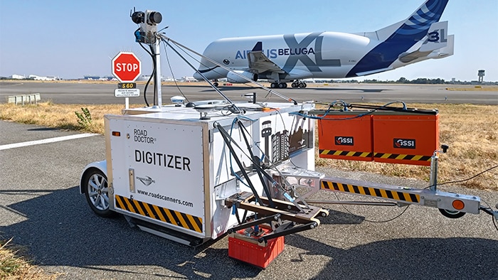 Digitizer stands in front of a plane 